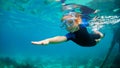 Child in snorkeling mask dive underwater in blue sea lagoon Royalty Free Stock Photo