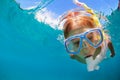 Child in snorkeling mask dive underwater in blue sea lagoon Royalty Free Stock Photo