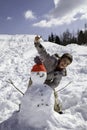 Child with snowman Royalty Free Stock Photo