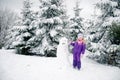 Child, snowman and winter forest Royalty Free Stock Photo