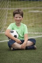 Child soccer football player. Boy with ball on green grass. Royalty Free Stock Photo