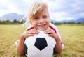 Child, soccer player and ball with portrait, smile and ready for game, field and girl. Outdoor, playful and sport for