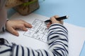 Child solves Japanese crossword sudoku