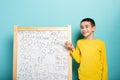 Child solves mathematical problem with abacus. Cyan background