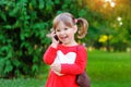 Child speaks on the phone in the park