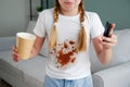 The child spilled coffee on his clothes. The concept of a stain on a t-shirt Royalty Free Stock Photo