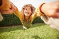 Child, spin and outdoor in pov, holding hands and happy for game with parent, holiday and backyard. Excited young kid Royalty Free Stock Photo