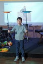 Child spinning white, blue, plates . Fun with Spinning Plates .balancing a spinning plate. Kids learning how to play spinning Royalty Free Stock Photo