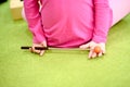 A child spins a percussion stick behind his back