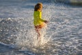 Child splashing in sea. Kid play with sea water drop. Little kid play in water and making splash. Child have fun with Royalty Free Stock Photo