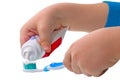 Child squeezes the toothpaste on the toothbrush Royalty Free Stock Photo