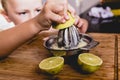 Child squeezing the juice of a lemon