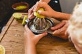 Child squeezing the juice of a lemon