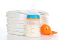 Child stack of diapers and baby feeding bottle with milk Royalty Free Stock Photo