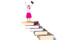 Child on staircase of books