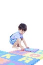 A Child stand and hold puzzle mat in Studio