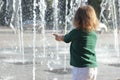 Child stand and play on street fountain on Philadelphia square over sunset near city hall in downtown Royalty Free Stock Photo