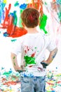 Child standing back and admiring his painting Royalty Free Stock Photo