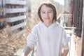 Child, standing on a balcony in a flat in Barcelona, enjoying sun and nice winter weather Royalty Free Stock Photo
