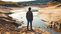 Child standing on a dry riverbed a representation of climate change and water scarcity issues Royalty Free Stock Photo