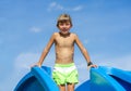 Child standing on a pool slide