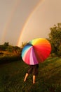 Child Standing in Rain With Colorful Umbrella Looking at Double Royalty Free Stock Photo