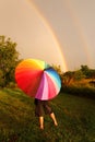 Child Standing in Rain With Colorful Umbrella Looking at Double Royalty Free Stock Photo