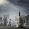 Child standing on a stack of books Royalty Free Stock Photo