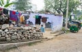 Child standing in the yard of poor asian family house