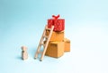 Child stands near a gift box on a pile of boxes. The concept of finding the perfect gift. Limited offer Buy a gift on time. Sale, Royalty Free Stock Photo