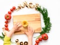 Child is stretching his curious hands to the Italian pasta ingredients, white background Royalty Free Stock Photo