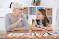 Child studying alphabet with teacher