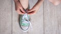 Child successfully ties shoes, close up on feet. Royalty Free Stock Photo