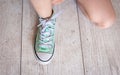 Child successfully ties shoes, close up on feet. Royalty Free Stock Photo