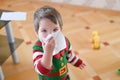 Child suffering from running nose or sneezing. Allergic little boy