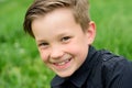 Child in summer park. Baby face closeup. Funny little kid boy close up portrait. Blonde kid, smiling emotion face. Happy Royalty Free Stock Photo