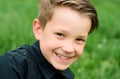 Child in summer park. Baby face closeup. Funny little kid boy close up portrait. Blonde kid, smiling emotion face. Happy Royalty Free Stock Photo