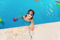 Child on summer vacation playing in the pool to splash happily Royalty Free Stock Photo