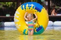Child sunbathing, swim with inflatable toy in swimming pool Royalty Free Stock Photo