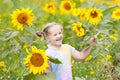 Child in sunflower field. Kids with sunflowers. Royalty Free Stock Photo