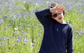 Child suffering from hot temperature and climate change, cornflower background Royalty Free Stock Photo