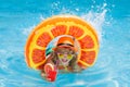 Child in sunglasses and summer hat drink summer cocktail and floating in pool. Summer kids vacation. Child boy swimming Royalty Free Stock Photo