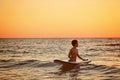 Child surfing on tropical beach. Family summer vacation in Asia. Kids swim in ocean water Royalty Free Stock Photo