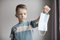 Child in a surgical mask. Boy wearing a medical mask for protect them self from coronavirus and flu outbreak Royalty Free Stock Photo