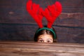 Child surprise .Christmas concept.Little girl in deer horns