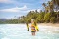 Child with swim fins snorkeling on tropical beach Royalty Free Stock Photo