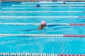child swimmer swim in swimming pool. Water sports and competition, learning to swim classes for children