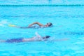 child swimmer swim in swimming pool. Water sports training and competition, learning to swim classes for children
