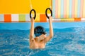 Child in swimming pool excersizing with sport rings Royalty Free Stock Photo