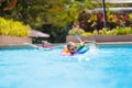 Child in swimming pool on toy ring. Kids swim Royalty Free Stock Photo